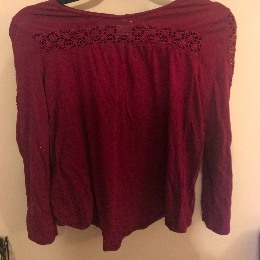 Cranberry red long sleeve top.
